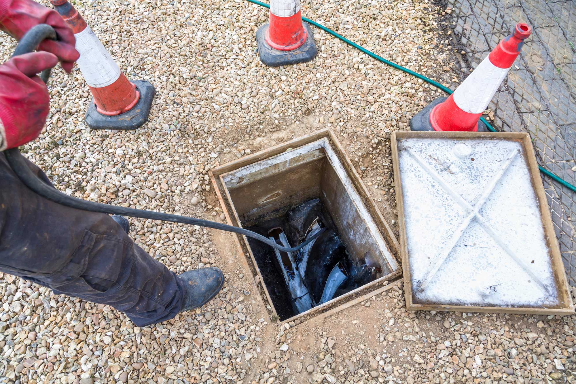 Paul Scott Drainage Solutions cleaning drain at manhole access